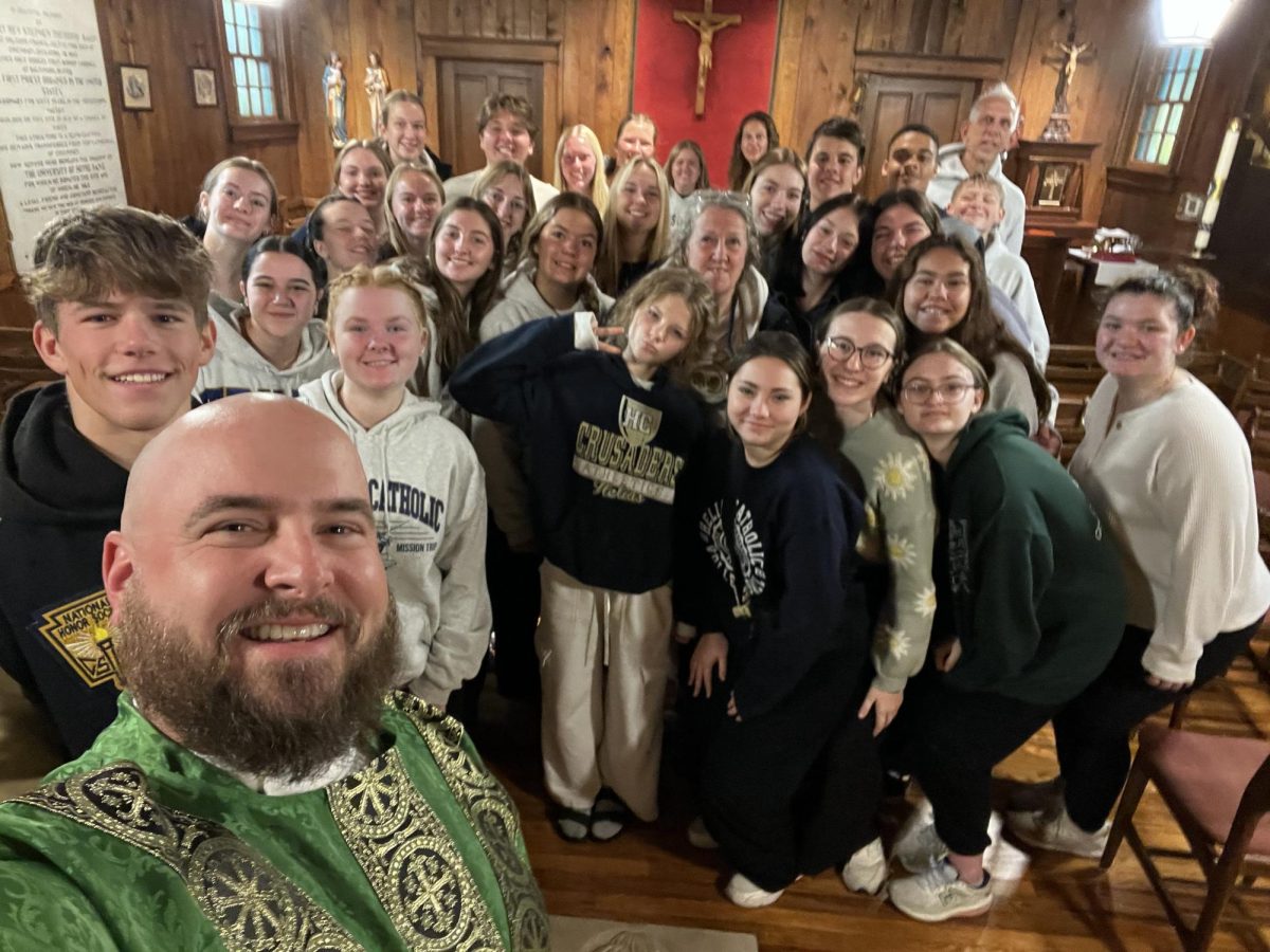 The students and staff who went on the Notre Dame Mission Trip at the Log Chapel, the starting point of the University of Notre Dame. 